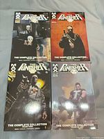 Front covers of four Punisher Max Complete Collection volumes 1,2,3,6