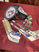 Lot overview showing duffle, mini sticks, poker chips, figure