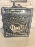 Front view showing cabinet, grille, control panel and single speaker