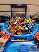 Close-up of Akedo figures grouped on blue arena platform