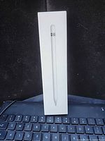 Front view of sealed Apple Pencil box resting on keyboard