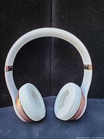Front view of rose gold Beats headphones showing ear pads and headband