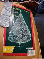 Box showing image and specs of 6.5 ft blue spruce artificial tree