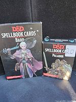 Front view of both Spellbook Card boxes: Bard and Paladin