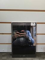 Front view of tablet showing cracked screen and home button