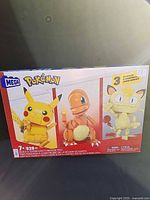 Front of box showing Mega Pokémon set with images of Pikachu, Charmander, Meowth and 529-piece count