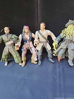 All four action figures standing side by side