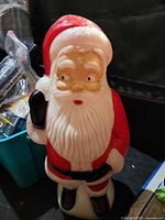 Front view of plastic blow mold Santa Claus figure showing paint details and attached power cord
