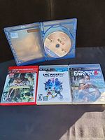 All four game cases displayed; NHL 16 case open showing disc