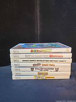 Stacked view of all seven Wii game cases showing titles on spines