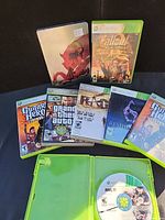 All eight game cases and disc displayed