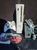 Front view of console, one controller, power brick, game discs