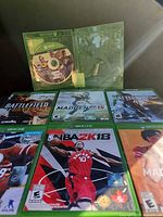 Six game cases visible, including an open case showing disc art