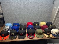 All 21 caps lined in three rows on table