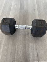 Full view of 25 lb hex dumbbell, both heads and handle visible