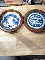 Both framed plates side by side on table