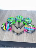 Group shot of all five paddles face-up