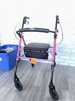 Front view of Carex rollator showing frame, seat, wheels, and basket