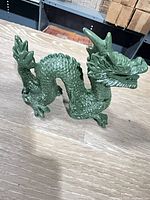Full left-side view of jade-green resin dragon