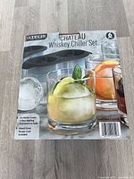 Front of sealed box showing brand, set name, images of glass and ice ball, and six-piece notation