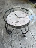 Full view of round glass-top clock end table