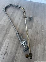 Entire pre-rinse faucet sprayer assembly laid out showing full length