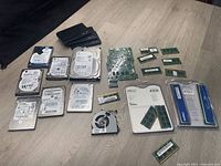 Overview of all hard drives, RAM sticks, circuit board and fan on tabletop