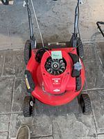 Top view of entire mower showing red deck, engine, handle