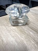 Front view of Versace Bright Crystal bottle showing clear glass and large faceted cap