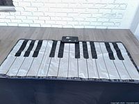 Top view of entire floor piano keyboard mat displayed on table