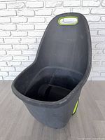 Front angled view showing deep plastic tub and handle cut-out