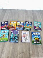 Nine hardcover children’s books laid out