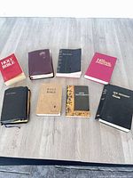 Eight religious books laid out on tabletop