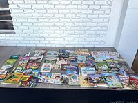 Wide view of table with approximately 34 assorted children’s books