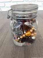Front view of Fido jar showing assorted jewelry inside