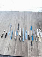 Full layout of knives and sheaths on tabletop