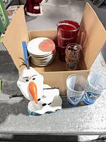 Lot overview showing vase, saucers stack, Olaf sippy cup, Dr. Seuss tumbler and Orlando Magic glasses