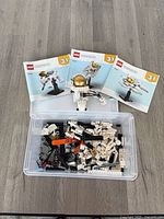 Overall lot showing instruction books, Astronaut model and bin of bricks
