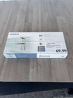 Factory-sealed Moen Liso faucet box front showing branding and product image