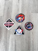 All four embroidered patches laid out on floor