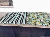 Four cushions displayed, two showing striped side, two showing floral side