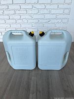 Front view of both Blitz water containers showing capacity markings and overall condition