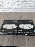Two boxed Artika Horizon LED ceiling fixtures