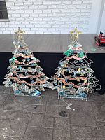 Both metal Christmas tree yard decorations front view