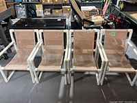 Front view of four PVC chairs showing frames and mesh seats