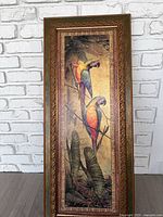 full view of elongated framed print with two macaws