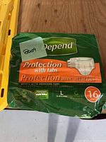 Front of sealed Depend Protection with Tabs package showing brand, product line, size Large, 16 count
