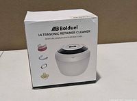 Front of product box showing Bolduel Ultrasonic Retainer Cleaner image and compatible items icons