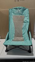 Front view of teal Brace Master folding beach chair