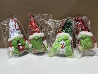 Front view of four sealed lighted Christmas gnome decorations